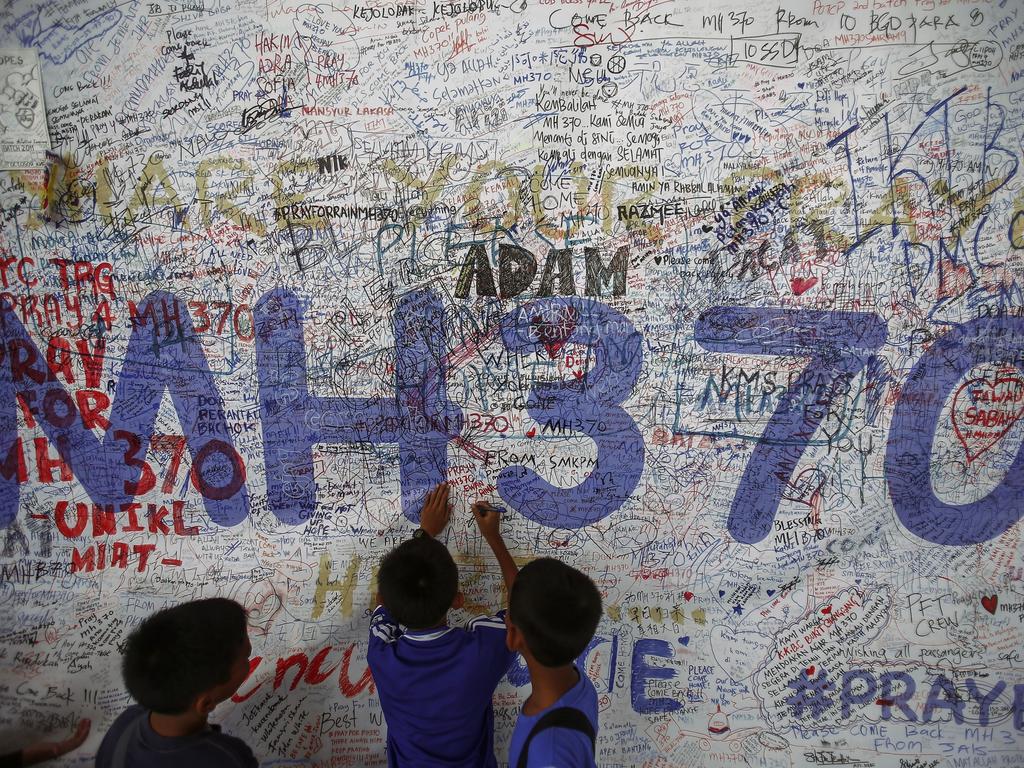 Children write messages of hope for passengers of MH370 at Kuala Lumpur International Airport in June 2014. Picture: Reuters