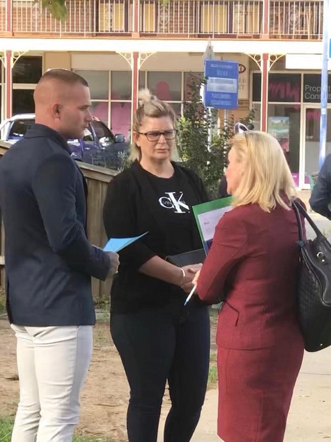 Jayden Reed (left) speaking to his lawyer with a female supporter on Tuesday.