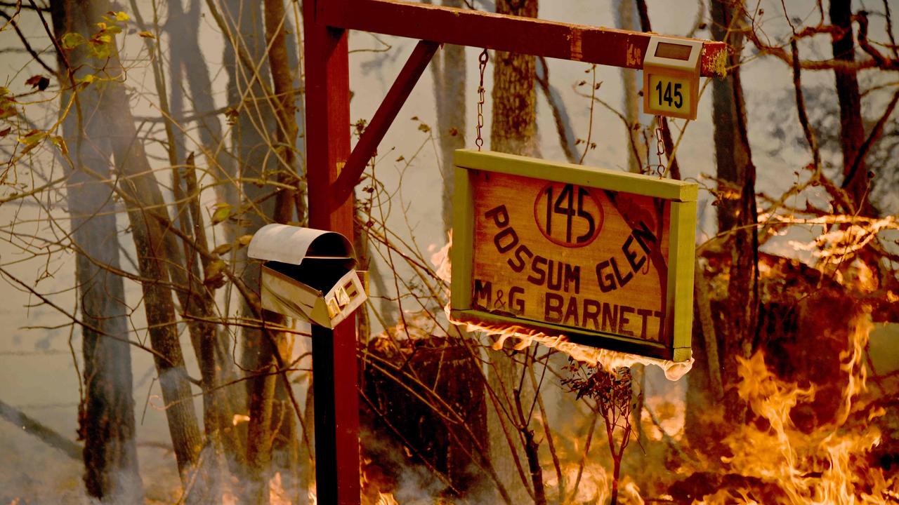 A bushfire burns outside a property near Taree. Picture: AFP