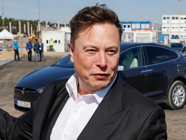 (FILES) In this file photo Tesla CEO Elon Musk talks to media as he arrives to visit the construction site of the future US electric car giant Tesla, on September 3, 2020 in Gruenheide near Berlin. - Whether the topic is transforming the automobile or conquering the next frontier of space, Elon Musk has shown a knack for captivating an audience beyond investors and science geeks. The brash Tesla CEO, now the world's wealthiest person following the electric automaker's meteoric rise, was the quintessential Silicon Valley disruptor -- except he no longer lives in California.On January 7, 2021, Musk surpassed Amazon Chief Executive Jeff Bezos as the world's wealthiest person. (Photo by Odd ANDERSEN / AFP)