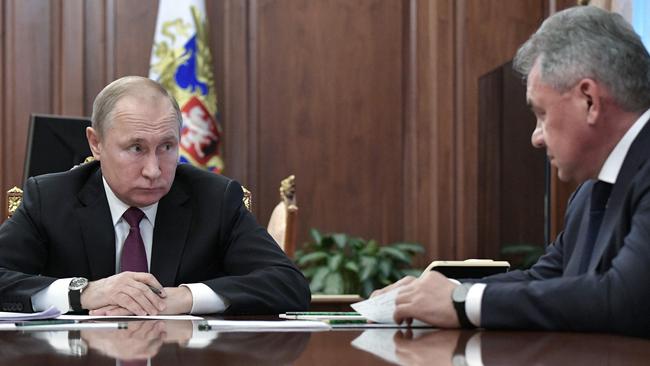 Russian President Vladimir Putin and Defence Minister Sergei Shoigu. Picture: AFP