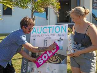 Kerry and Katie Warren just after snapping up their new home, 29 Cinnamon Drive, Glenella, at an Explore Property auction over the weekend. Picture: Navarone Farrell