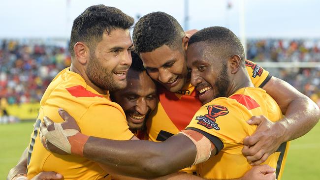 Rhyse Martin, Justin Olam, Nene McDonald and Watson Boas of Papua New Guinea celebrate a win.