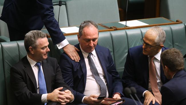 Christopher Pyne and Prime Minister Malcolm Turnbull console Deputy PM Barnaby Joyce yesterday. Picture Kym Smith