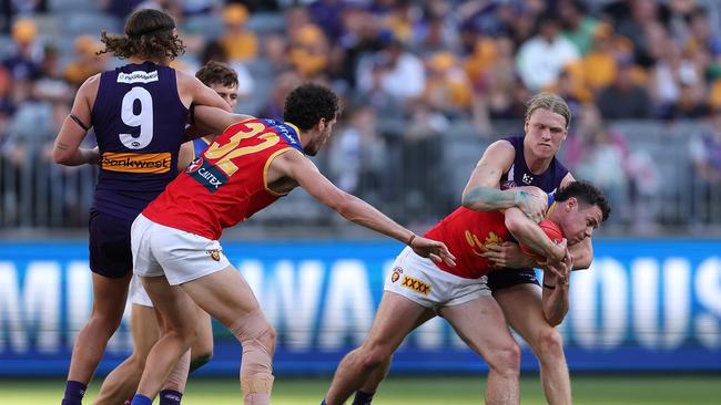 Lion Lachie Neale is held up by Fremantle’s Hayden Young during their clash at Optus Stadium, on August 06, 2023, in Perth, Australia. (Photo by Paul Kane/Getty Images)