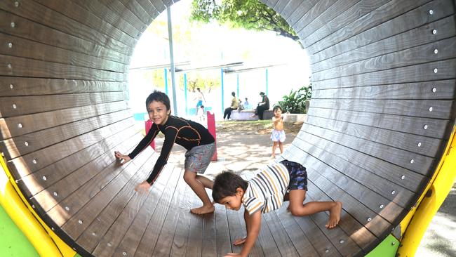 Brothers Jonty and Alby Rungan stay cool, playing in the shade at Muddy's Playground. Photo: Catherine Duffy