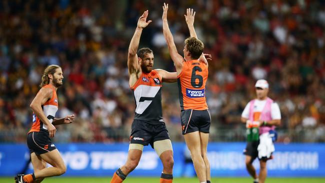Shane Mumford and Lachie Whitfield celebrate a goal against Hawthorn. Picture: Getty
