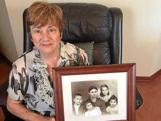 MEMORIES: Helen Perikkentis holds a photograph of her family she immigrated to Australia with in 1959. Picture: CONTRIBUTED