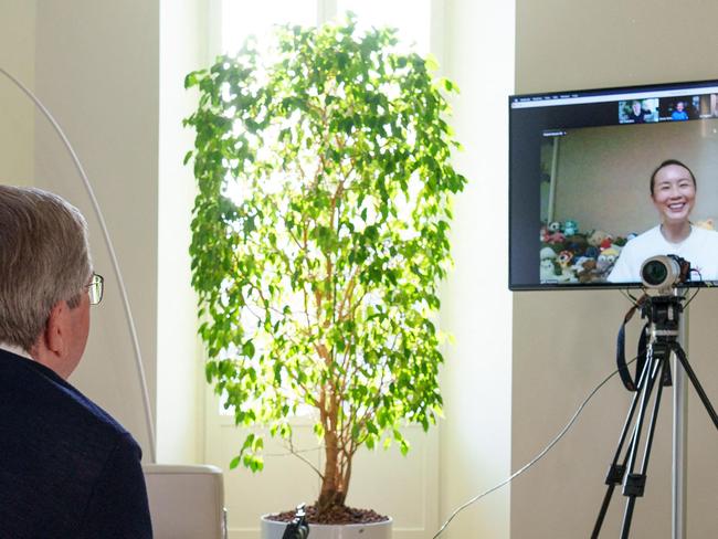 A handout photo posted on the International Olympic Committee website on November 21, 2021 shows IOC President Thomas Bach holding a video call with Chinese tennis star Peng Shuai, as international pressure mounted for information about her wellbeing. (Photo by Greg MARTIN / OIS/IOC / AFP) / RESTRICTED TO EDITORIAL USE - MANDATORY CREDIT "AFP PHOTO / IOC / INTERNATIONAL OLYMPIC COMMITTEE / GREG MARTIN" - NO MARKETING - NO ADVERTISING CAMPAIGNS - DISTRIBUTED AS A SERVICE TO CLIENTS