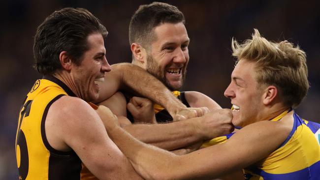 James Frawley and Isaac Smith of the Hawks wrestle with Oscar Allen. Picture: Paul Kane/Getty Images.