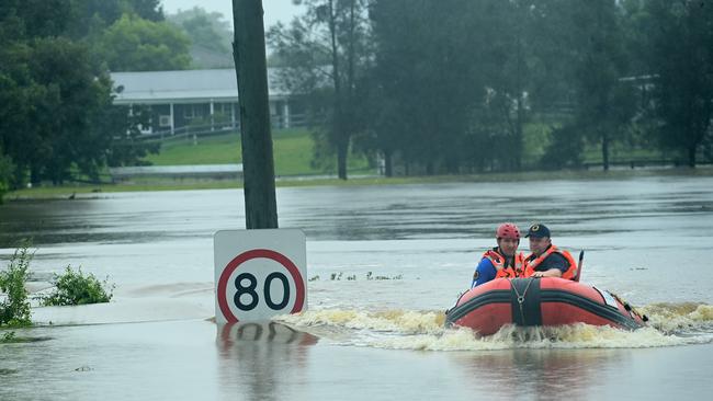 An SES boat patrols the flooded waterways of the Hawkesbury River in Vineyard, NSW. Rain continues across the state threatening homes. Picture: NCA NewsWire / Jeremy Piper