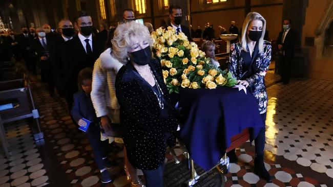 Patti Newton, daughter Lauren Newton and her husband Matt Welsh, along with pallbearers carry the casket of Bert Newton following his state funeral at St Patrick's Cathedral. Picture: Darrian Traynor/Getty Images