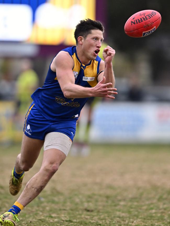 Noble Park’s Jackson Sketcher fires off a handball. Picture: Andy Brownbill