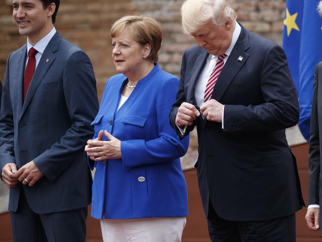 President Donald Trump adjusts his jacket during a photo with G7 leaders at the Ancient Greek Theater of Taormina, Friday, May 26, 2017, in Taormina, Italy. Picture: AP.