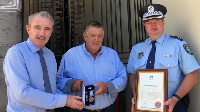 BRAVEHEART: Kevin Dowd's selfless act in rescuing a stranger man from his burning car shortly before it exploded was recognised with a Royal Humane Society of NSW Bronze Medal Bravery Award, presented by Federal Member for Page Kevin Hogan. Richmond Police District Commander Superintendent Scott Tanner also presented Mr Dowd with a commendation. Photo: Alison Paterson