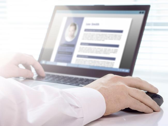 Job seeker and applicant writing his resume and CV with laptop. Modern and visual electronic curriculum vitae in social media. Work experience document in computer screen. Job search and unemployment.