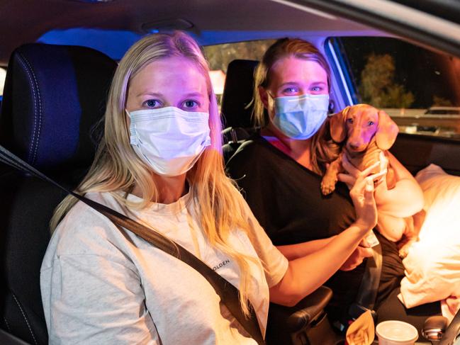 Wodonga Victoria, AUSTRALIA - Herald Sun - 2nd January, 2020:Hume Freeway check point on the Victorian side of the border near Wodonga just before midnight when the border closes to people traveling from NSW to Victoria.Kelli Rippon and Rachel Bartlett with Meisie (dog)The last two people to be allowed into Victoria on the Hume Freeway seconds from midnight. They did have a pass to enter from Queensland.They travelled from Brisbane - Dubbo then into VictoriaBYLINE -  Simon Dallinger