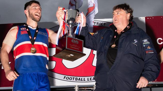 Keilor captain Kane Barbuto and coach Mick McGuane hoist the silverware after the club’s 2019 EDFL grand final win. Picture: Jamie Morey