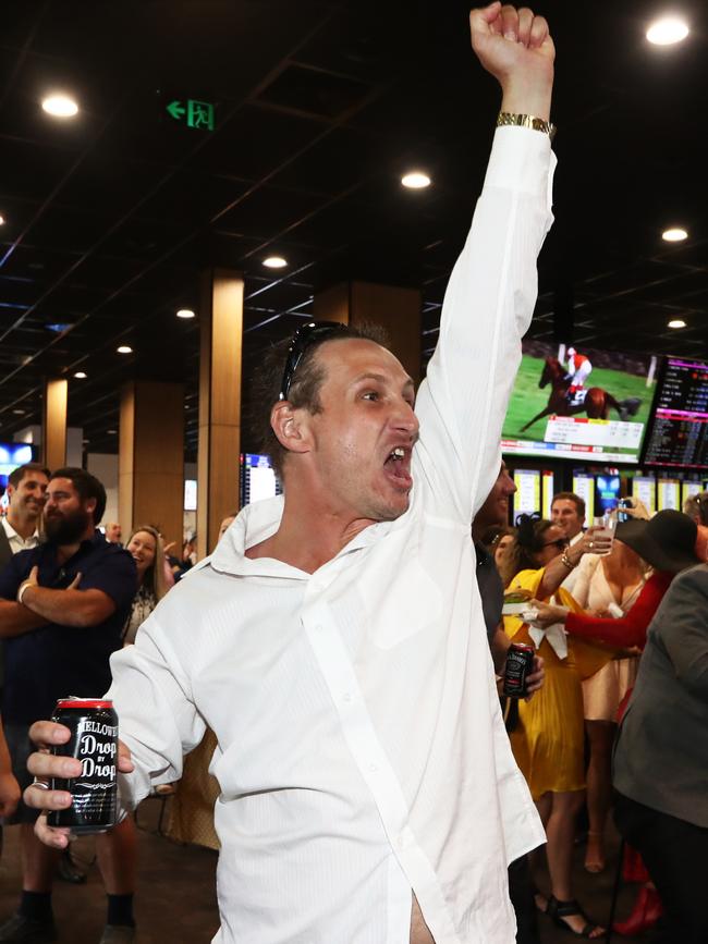 A Racegoer watches the Melbourne Cup at The Gold Coast Turf Club. Photograph: Jason O’Brien.