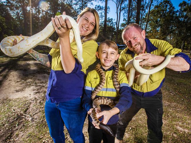 Gold Coast and Brisbane snake catcher Tony Harrison, wife Brooke and son Jensen with snakes for a weekend package.Picture: Nigel Hallett