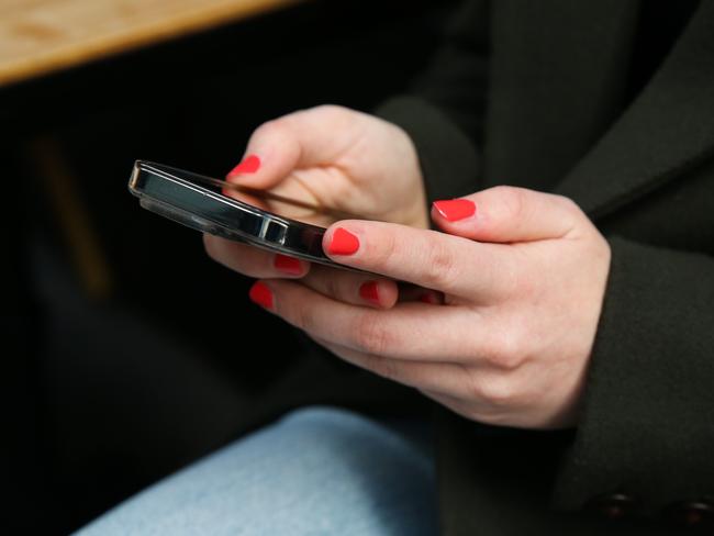 SYDNEY, AUSTRALIA - Newswire Photos - JULY 25 2023: People are seen on their mobile phones during lunch time in the Sydney CBD. Picture: NCA Newswire / Gaye Gerard