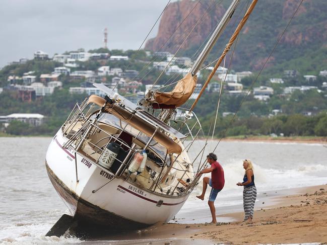 Peter Bright inspects the damage to his beached yacht, which washed ashore at Pallarenda after Tropical Cyclone Kirrily hit the Townsville area. Picture: Adam Head