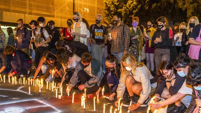 Protesters light candles after the death in custody. Picture: Richard Walker