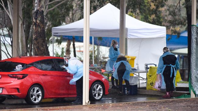 Workers at the pop up Gawler testing clinic at Trinity College. Picture: Jason Katsaras