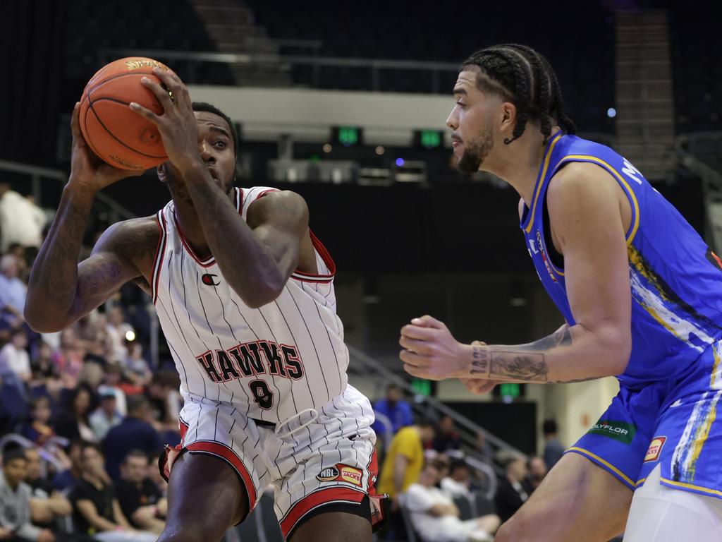 GOLD COAST, AUSTRALIA - SEPTEMBER 20: Gary Clark of the Hawks drives to the basket under pressure from DJ Mitchell of the Bullets during the 2023 NBL Blitz match between Brisbane Bullets and Illawarra Hawks at Gold Coast Convention and Exhibition Centre on September 20, 2023 in Gold Coast, Australia. (Photo by Russell Freeman/Getty Images for NBL)