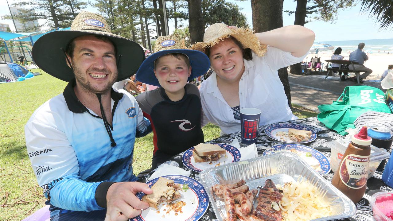 People celebrating Australia Day at Burleigh Heads. (L-R) Tim Penna, Jaxon Penna, 9, and Steph Cracknell of Brisbane. Pic Mike Batterham