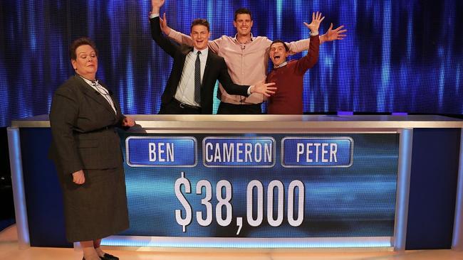 Former AFL ruckman Cameron Wood celebrates with fellow contestants after winning on The Chase Australia.