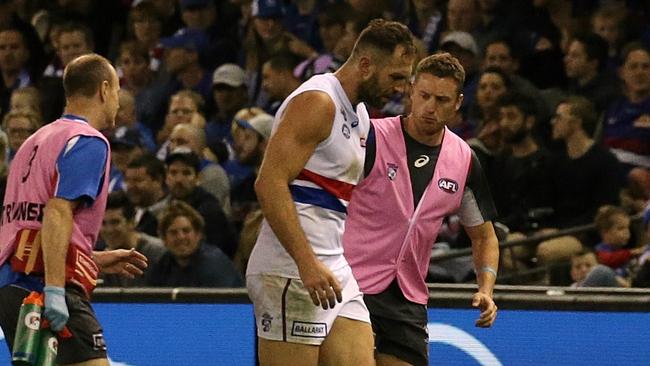 Travis Cloke is helped off the ground after copping a hard bump from Jack Ziebell. Picture: Wayne Ludbey