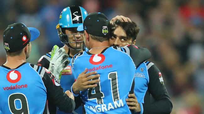 Strikers teammates mob Rashid Khan after dismissing Cameron White of the Renegades during the Big Bash League in Geelong. Picture: Scott Barbour/Getty Images