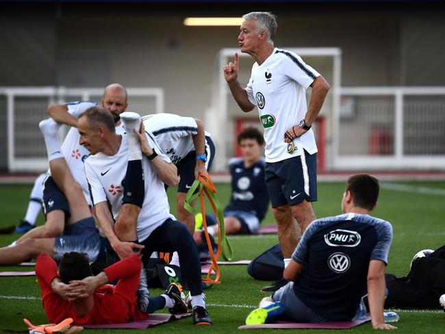 France's head coach Didier Deschamps (C) talks to players during a team training session.