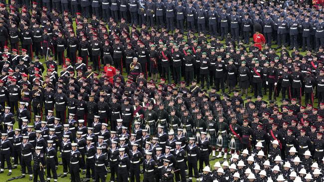 Members of the armed forces stand in formation on the lawn of Buckingham Palace following the coronation of King Charles III. Picture: Getty Images