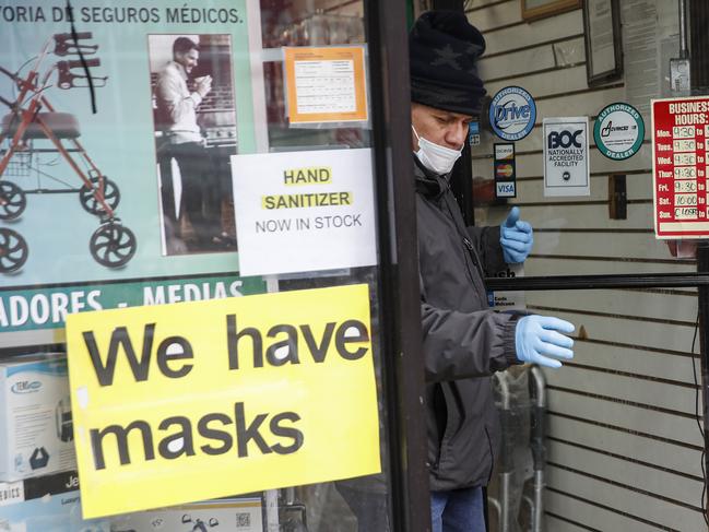 A customer leaves a shop advertising personal protective equipment in New York. Picture: AP