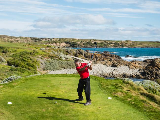 A golfer tees off on the world-class Cape Wickham Golf Links course on King Island. Picture: STU GIBSON/TOURISM TASMANIA