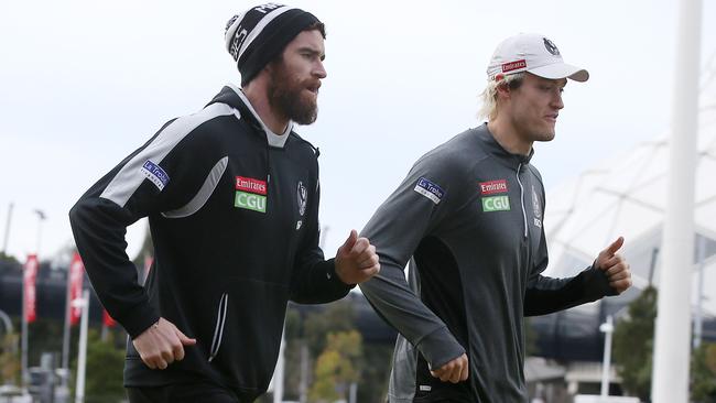 Tyson Goldsack and Darcy Moore run laps at Collingwood training. Picture: Michael Klein