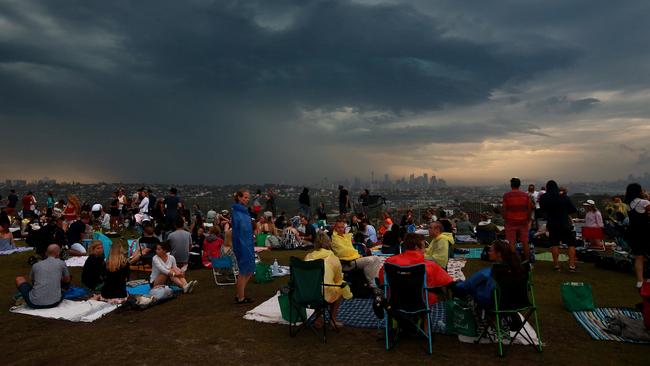 People at Dudley Page Reserve in Dover Heights were evacuated after concerns of lightning strikes once the storm front moved in across the harbour. Picture: Toby Zerna