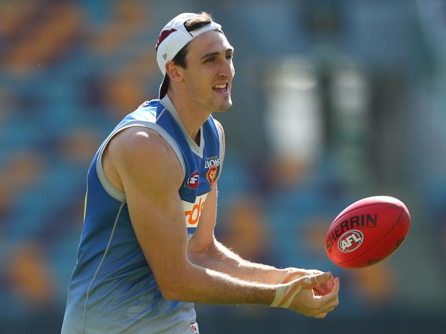 BRISBANE, AUSTRALIA - AUGUST 13: Oscar McInerney handballs during a Brisbane Lions AFL training session at The Gabba  on August 13, 2019 in Brisbane, Australia. (Photo by Chris Hyde/Getty Images)