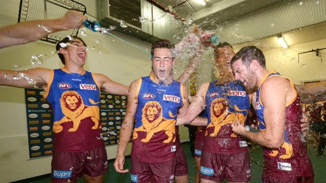 Sam Docherty (righht) celebrates a win with his former teammates. Picture: Darren England.