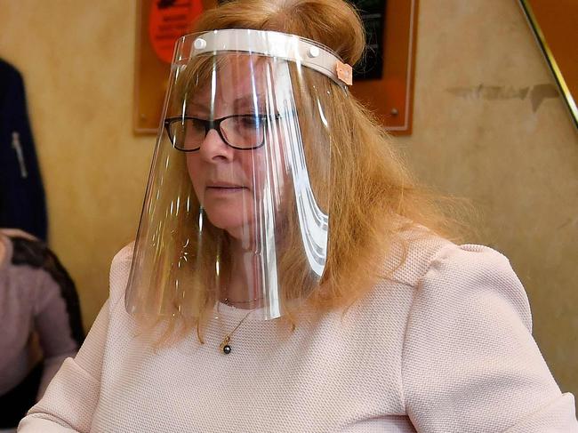 A cashier wearing a protective face shield speaks with a customer wearing a mouth mask in a shop in Bordeaux, southwestern France, on May 11, 2020 on the first day of France's easing of lockdown measures in place for 55 days to curb the spread of the COVID-19 pandemic, caused by the novel coronavirus. (Photo by GEORGES GOBET / AFP)