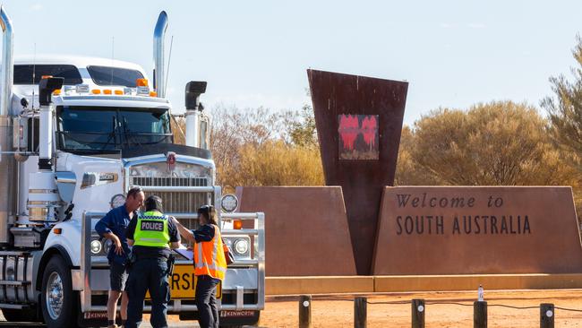 A road train is stopped by NT Police at the NT/SA border on March 24, 2020, after the Territory shut its borders at the start of the Covid-19 pandemic. Picture: Emma Murray