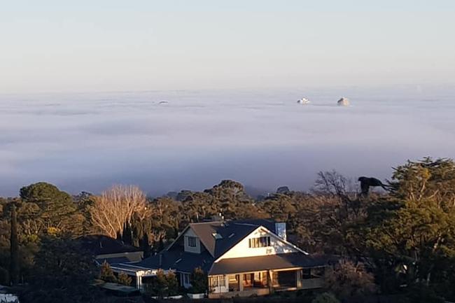 Fog rolls in over the city below the Mt Osmond Centre track on July 14. Picture: Andrew Hawkes