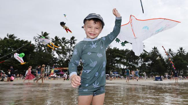 Bohdi Hook, 3, flies a kite which is dwarfed by the huge kites flying above Four Mile Beach when the attended Port Douglas Carnivale's family beach day on Saturday. Picture: Brendan Radke