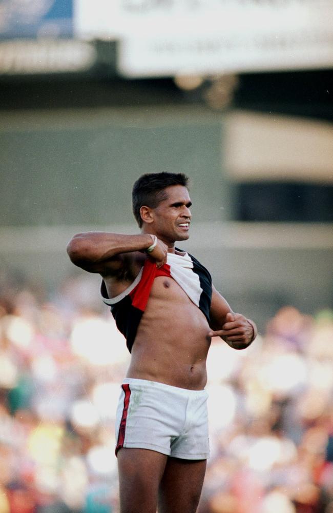 In 1993, St Kilda star Nicky Winmar lifted his guernsey and pointed to his stomach, telling Australia: “I’m black and I’m proud.” The AFL player had been racially abused by Collingwood supporters that day, but wasn’t going to sit back and take it anymore. This picture by John Feder remains one of the most iconic photos ever taken not just in footy, but Australian sport.