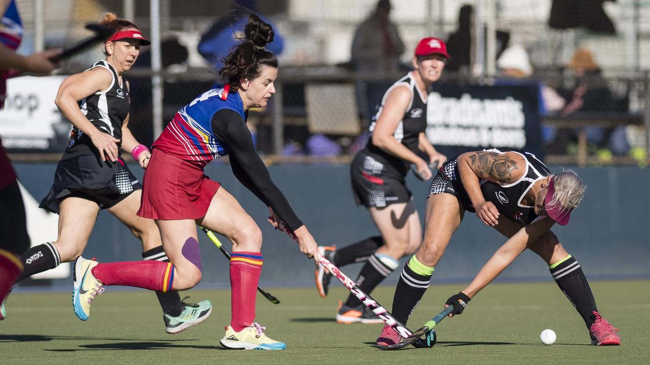 Rachael Stokes of Brisbane 2 is tackled by Tammie Clark of Mackay 1.