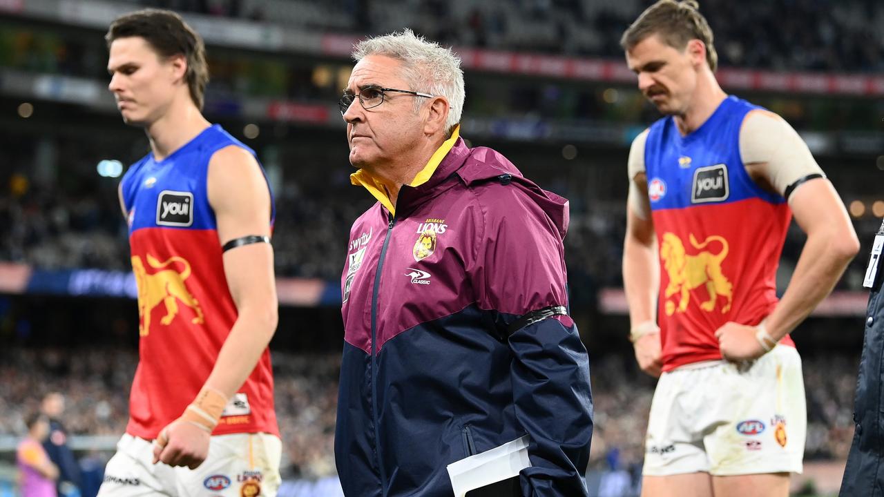 MELBOURNE, AUSTRALIA - SEPTEMBER 16: Eric Hipwood, Joe Daniher and Chris Fagan the coach of the Lions look dejected after losing the AFL First Preliminary match between the Geelong Cats and the Brisbane Lions at Melbourne Cricket Ground on September 16, 2022 in Melbourne, Australia. (Photo by Quinn Rooney/Getty Images)