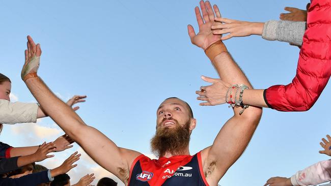 Max Gawn of the Demons high five fans after beating the Carlton Blues at the MCG.