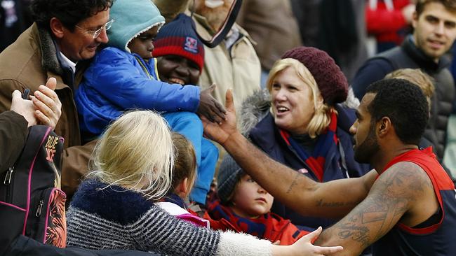 Heritier Lumumba and a Melbourne fan after a game. Picture: Wayne Ludbey